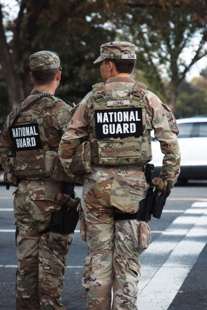 Mastering the First Impression: Your intriguing post title goes here Two National Guard soldiers in uniform standing outdoors on a city street.